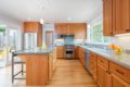 a kitchen with custom wood kitchen cabinets